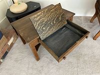 Photo showing the writing desk with the drawer opened, revealing the hinged writing surface inside the drawer compartment.