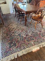 Full view under dining table showing overall pattern, fringe and condition
