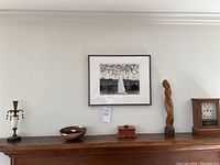 All six items arranged on a wooden mantel under a framed photograph