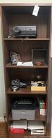 Full view of dark wood four-shelf cabinet with all items installed