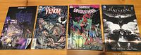 Four comic books laid out showing front covers: Venom Variant Editions 1 and 3, Spiderman Darkhold Volume 1, and Batman Arkham Knight Volume 1.