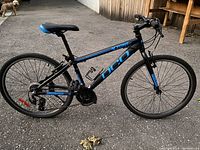 Full side view of the DCO XZone bike on blacktop, showing frame, wheels, handlebars, and saddle in good condition.