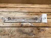 Image of the black metal Ikea Utsaga towel rack in original plastic packaging, displayed on wooden surface, showing curled end mounts and straight bar.