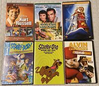 Photo of six DVD cases featuring Disney Kurt Russell 4-Movie Collection, Darby O'Gill and the Little People, The Sword in the Stone, Scooby-Doo! Mystery Incorporated, Scooby-Doo Complete Series, Alvin & The Chipmunks: The Squeakquel