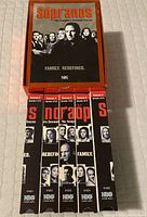 Five VHS cassettes arranged in original box, showing front cover with The Sopranos cast image and orange background.
