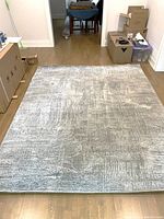 Full view of the 8'1" x 10'0" area rug laid on hardwood floor showing overall size and condition.