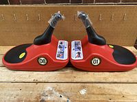 Two Zipfy Mini Luge sleds model #08 and #01 placed side by side, showing front and top views.