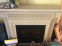 Full front view of the electric fireplace insert housed in a stone mantel surround showing overall structure and the fireplace opening.