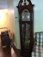 Full view of clock case showing cherry finish and design