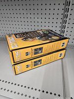 Side view of two stacked yellow Zotac GeForce 9800GT boxes showing product packaging and branding