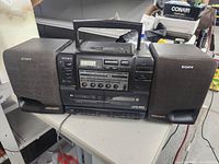 Front view of Sony CFD-555 portable stereo system with both detachable speakers attached, showing overall unit and controls.