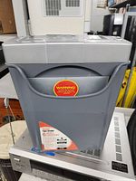 Front view of the Executive Machines EPS-6IIX shredder showing the gray waste bin with warning label and control panel on top.