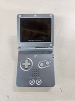 Top view of the opened Nintendo Game Boy Advance SP console showing the screen and button layout.