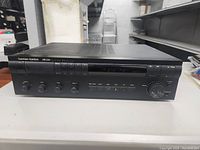 Front view of the Harman Kardon HK3300 stereo receiver showing the entire front panel with power button, tuning controls, and input selectors.