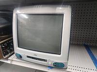 Front view of Apple iMac G3 with CRT display, speakers, and front drive slot.