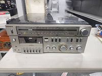 Front view of Magnavox BCI760 audio system showing cassette tape deck, buttons and knobs.