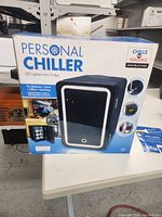 Boxed Personal Chiller LED Lighted Mini Fridge showing front of retail packaging with product image and features.
