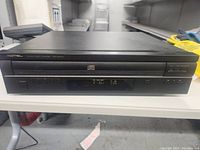 Front view of the Rotel ACC-940AX CD Multidisc Changer showing the disc tray, digital display, and control buttons.