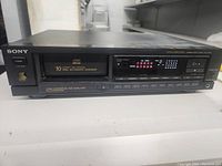 Front view of Sony CDP-CX66 showcasing 10 disc automatic changer slot and power button on left side.