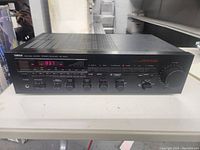Full front view of Yamaha RX-500U stereo receiver showing display, buttons and dials.