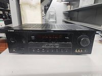 Full front view of Yamaha RX-V363 AV receiver showing display, buttons, and volume knob.