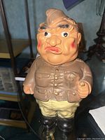 Front and sides view of the vintage ceramic army sergeant coin bank.