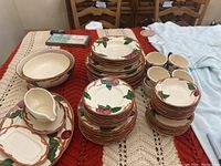 Photo showing full set of Franciscan Apple dinnerware items arranged on table including plates, bowls, cups, saucers, gravy boat, and serving bowl.