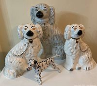 Group of four dog figurines displayed together