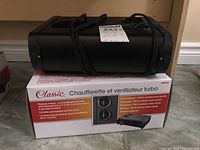 Classic Turbo Heater & Fan portable heater on top of its original box showing product and controls.