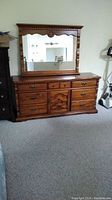 Full front view of solid pine dresser with mirror above, showing seven drawers and solid pine frame.