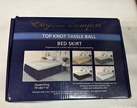 Box showing Elegant Comfort Top Knot Tassle Ball Bed Skirt, size Queen/King 78x80+16 inches with images of bed dressed with bed skirt.