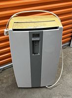 Front view of the Danby portable air conditioner showing white and gray body with power cord wrapped around.