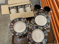 Corelle bowls, mugs, and two plates showing colors and patterns