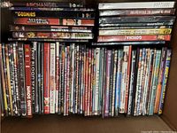 Photo showing assorted DVD and Blu Ray movies including titles Archangel, The Goonies, Never Say Never Again, True Blood Season 1, Falling Down, Monsieur Ibrahim, Scream 4, The Shining, and others.