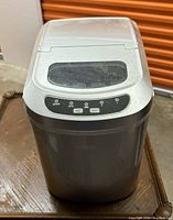 Salton ice cube maker with control buttons on top and a transparent window on the lid.