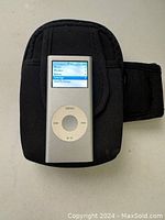 Apple iPod in running case showing screen menu interface active.