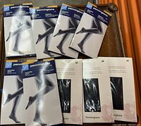 Display of 8 pairs of brand new Penningtons brand pantyhose in original packaging, size 5X, mostly black color