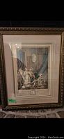 Photo of a framed historical scene print with ornate gold-embellished frame and double matting.