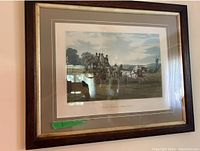 Framed horse print titled "The Early Delivery" with a wood frame and cream-colored mat, showing a stagecoach drawn by horses in countryside setting.