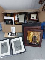 Overview of box with various frames inside and some stacked outside showing different styles and colors