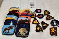 Full group photo showing 10 Girl Guide patches and over 20 animal patches laid out on a white background