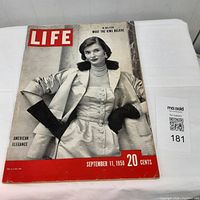 Front cover of Life Magazine, September 11, 1950 issue showing a black and white photo of a woman dressed in satin with fur accents and long black gloves.