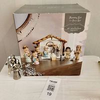 Box showing image of all 11-piece nativity set figurines including stable. Figures include Mary, Joseph, baby Jesus in manger, Three Wise Men, shepherd, angel, animals.