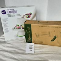 Boxes for Pampered Chef Cookie Press and Wilton Trim-N-Turn Ultra Cake Turntable shown side by side on white cloth background.