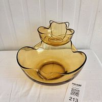 Full view of amber glass chip and dip set showing both bowls with crimped edges and metal supports for dip bowl.