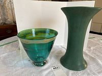 Photo showing both vases side by side on white cloth with white background.