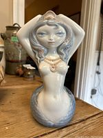 Front view of porcelain mermaid planter showing full figure and planter cavity