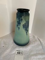 Front view of ceramic vase showing grape motif and gradient glaze