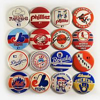 Top view of all 16 vintage MLB baseball team logo pinback buttons arranged in a 4x4 grid against a white background