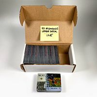 Photo of open box containing stack of acetate hockey cards with post-it note reading '97 McDonalds Upper Deck Ice'. One card featuring Wayne Gretzky is displayed outside the box.